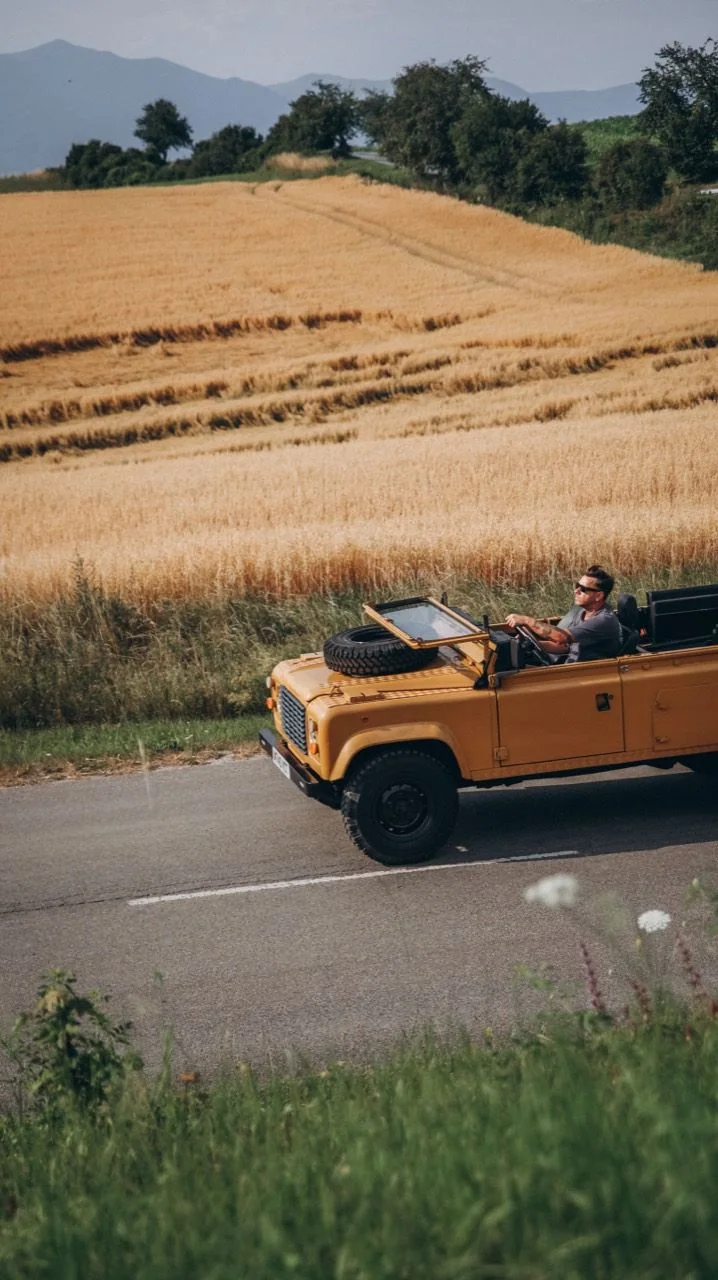 Side view of the Bahama Gold Defender 110 driving beside a wheat field