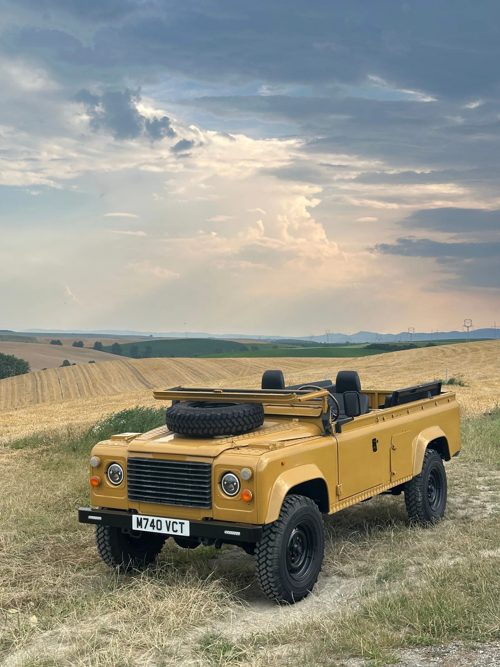 Front view of the Defender 110 beneath a dramatic sky