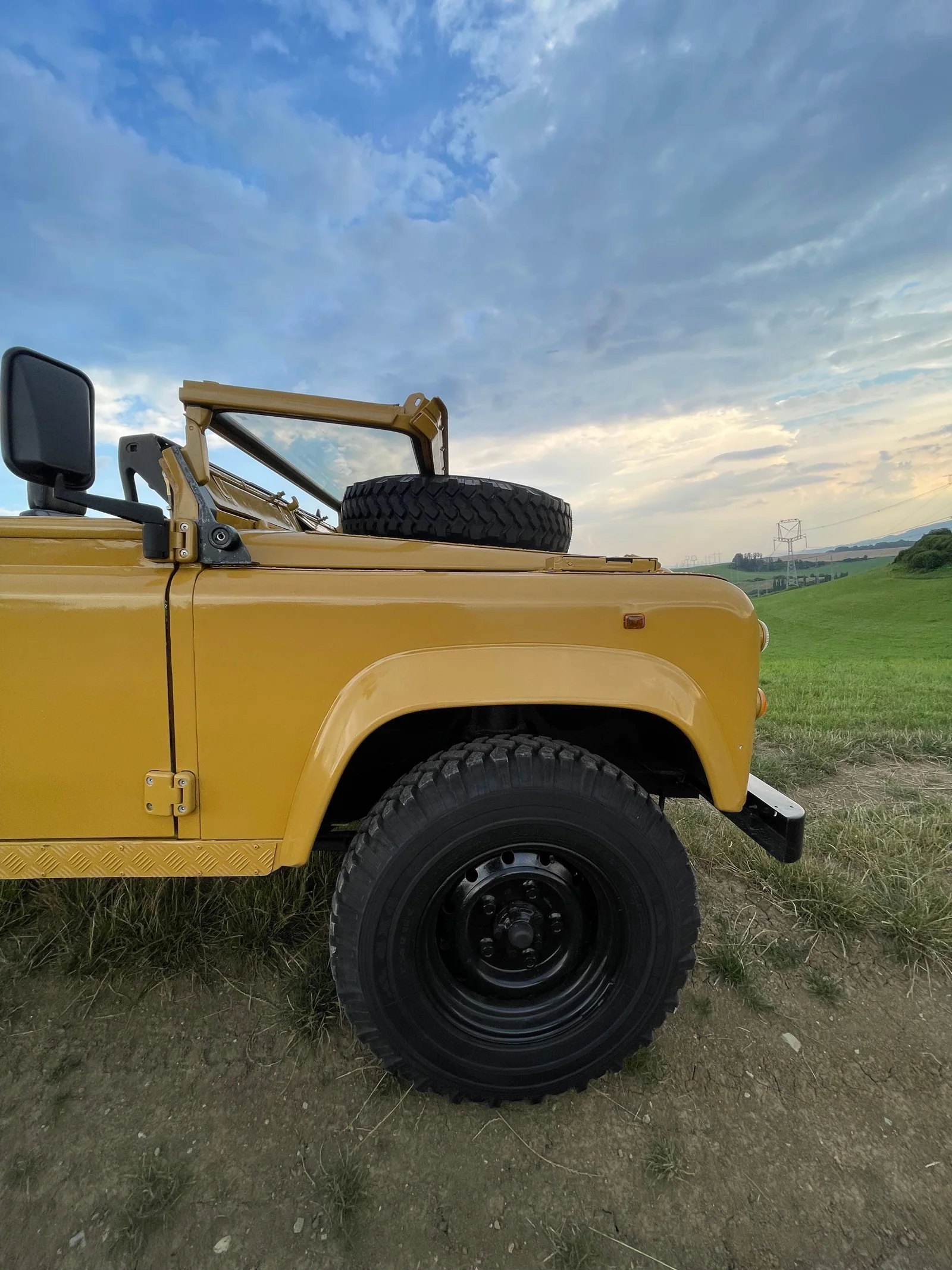 Close view of the Defender front wing, wheel and bonnet-mounted spare