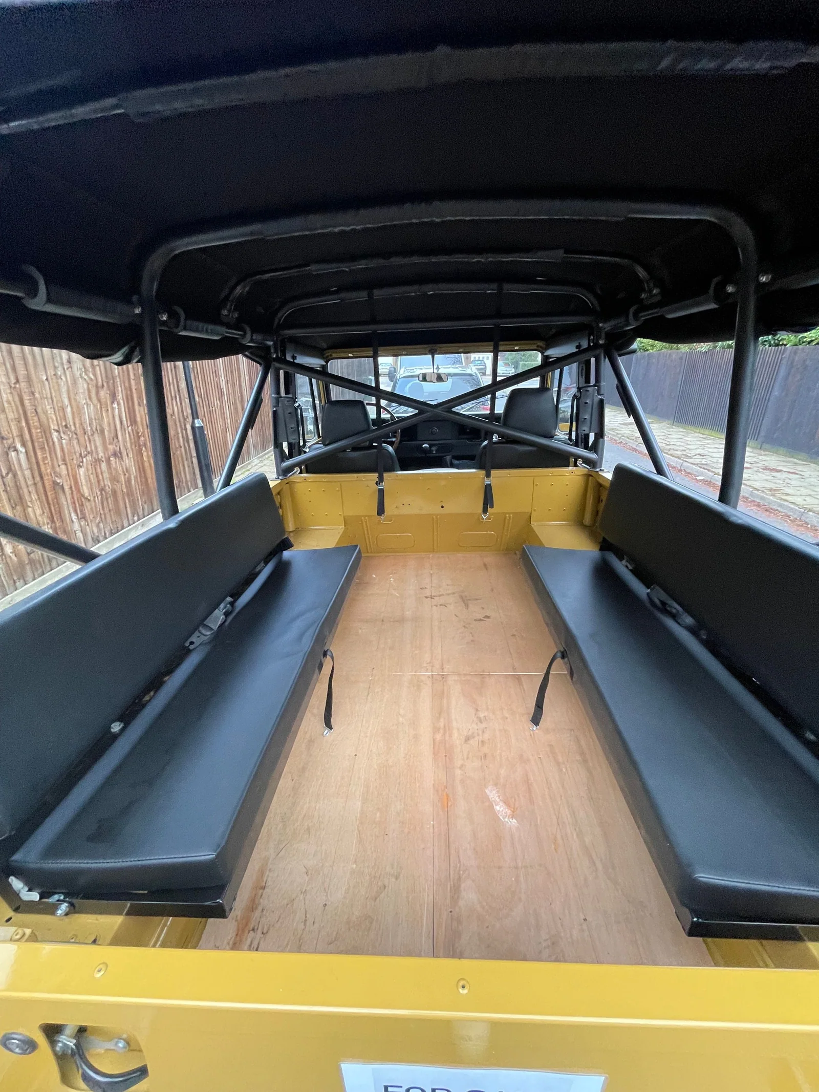 Rear load area with black inward-facing bench seats lowered