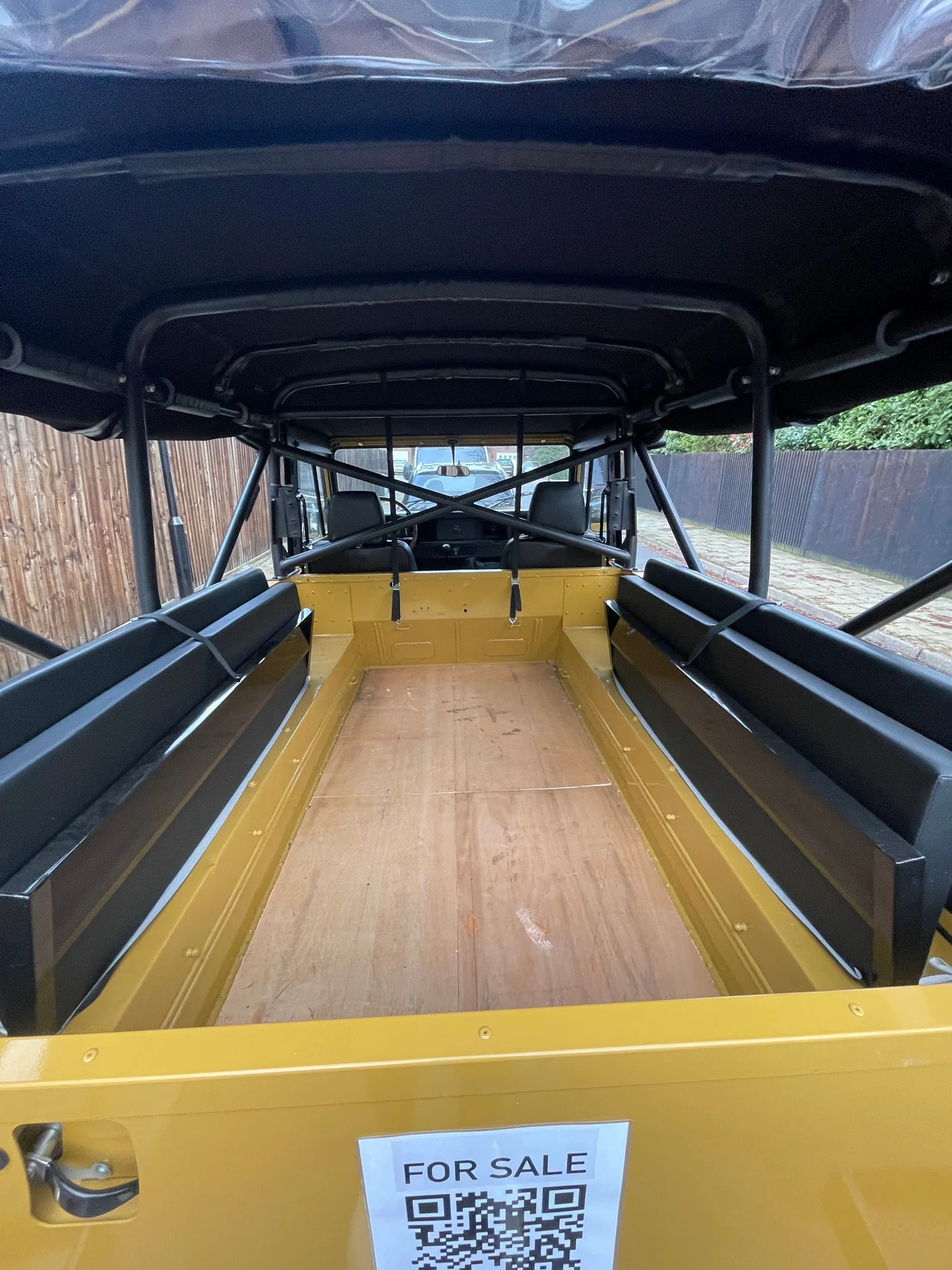 Rear load area with both bench seats raised beneath the soft top