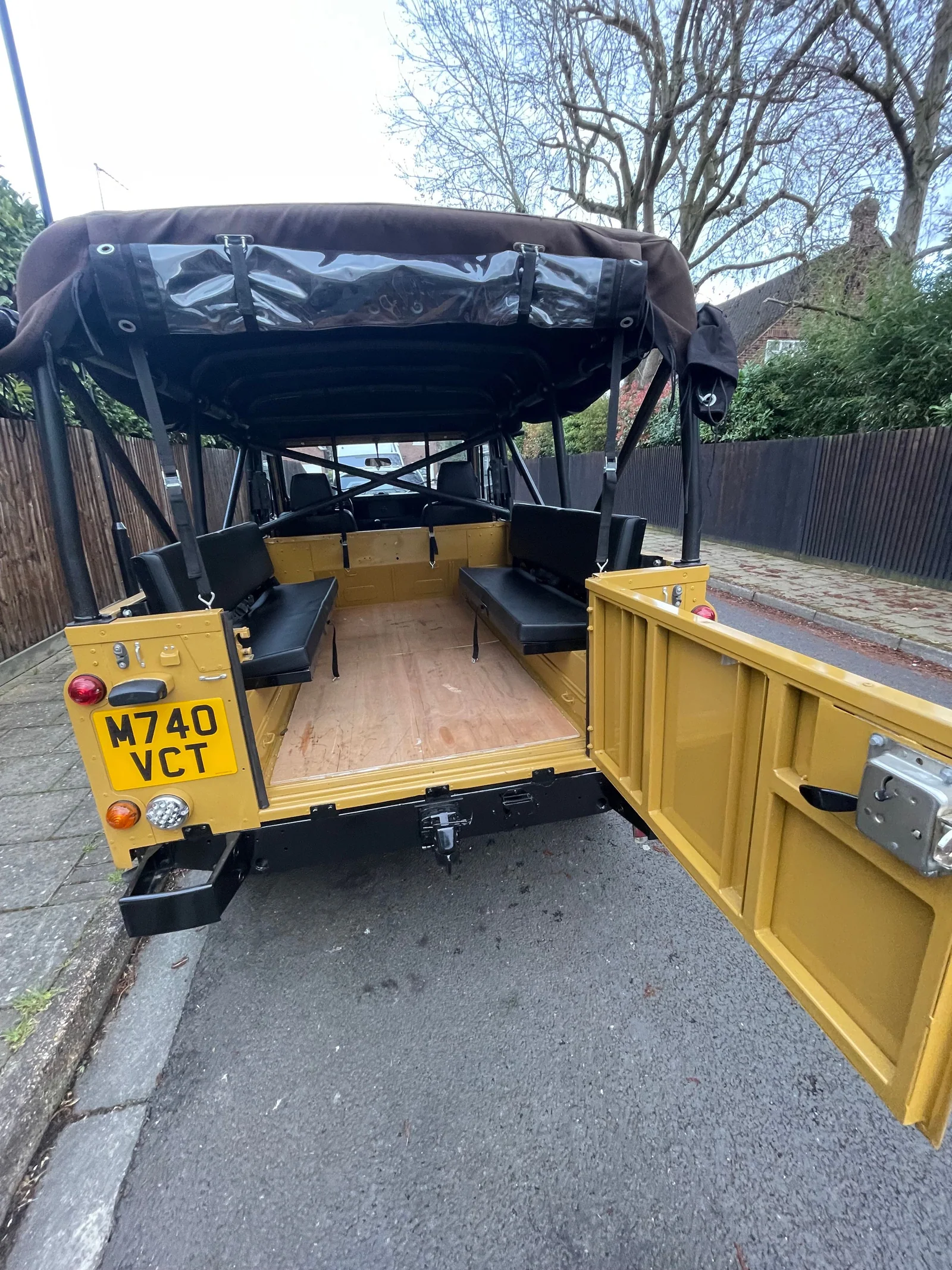 Open rear door showing the Defender load area and bench seats