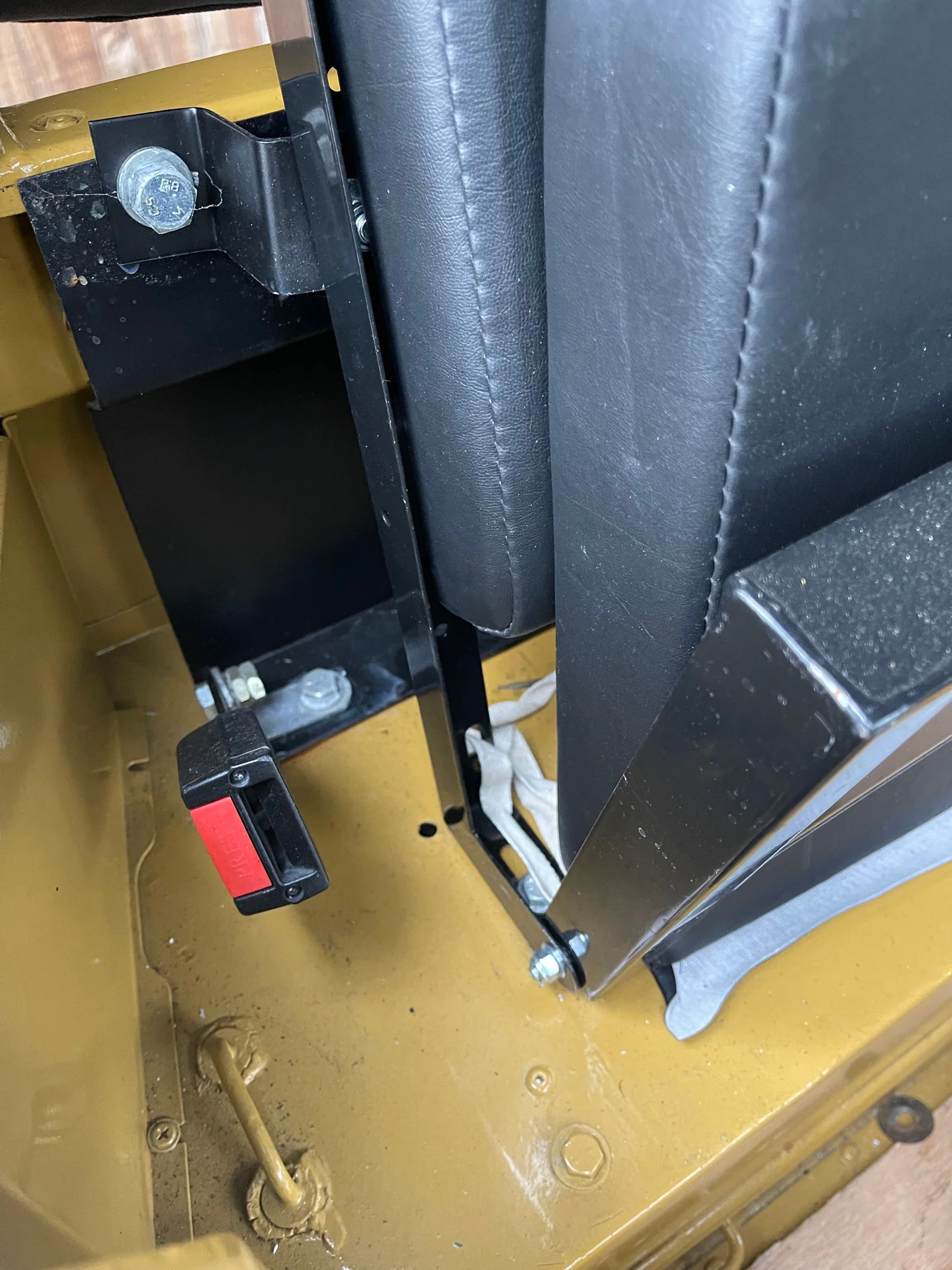 Close-up of rear bench-seat mounting and seat-belt buckle