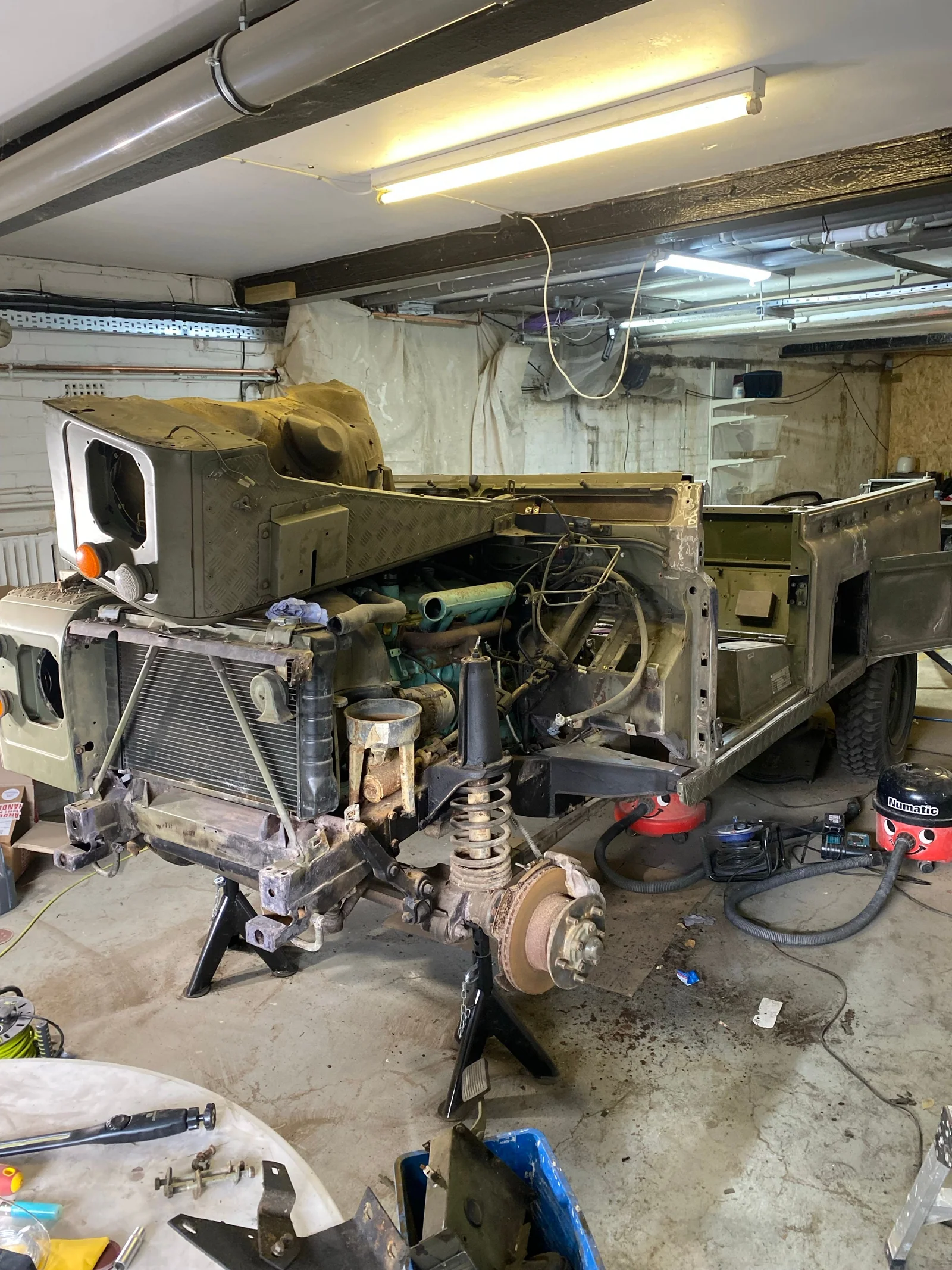 Defender body and front running gear exposed during restoration