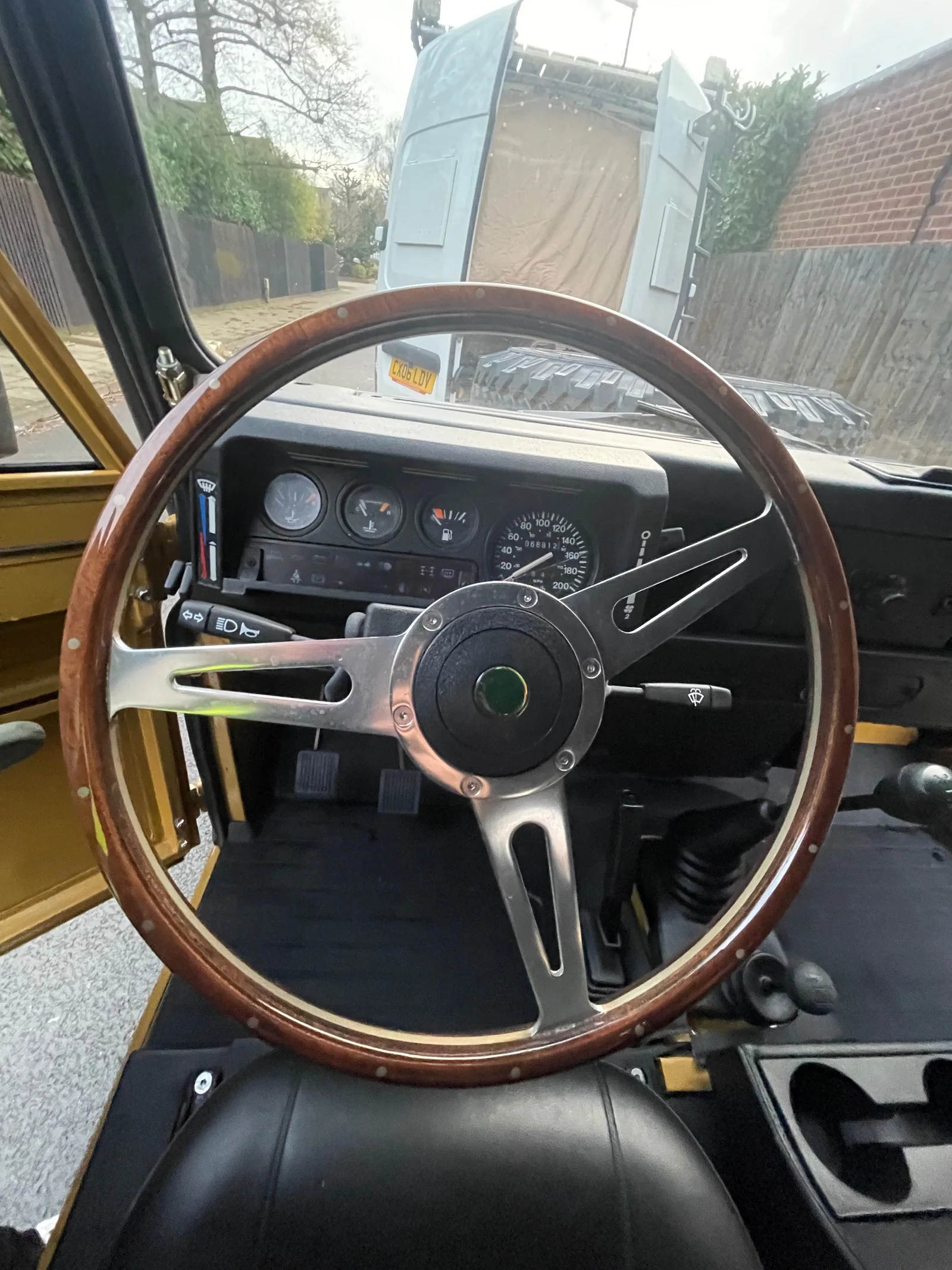 Wooden steering wheel and instrument cluster in the left-hand-drive Defender