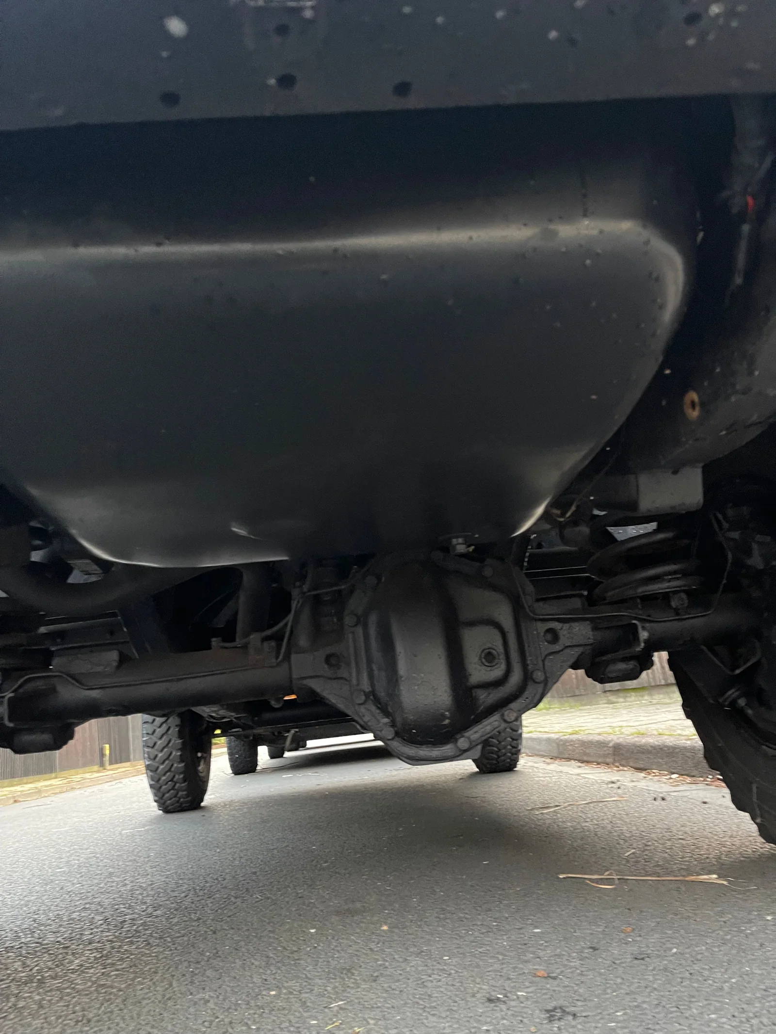 Close underbody view of the Defender differential and fuel tank